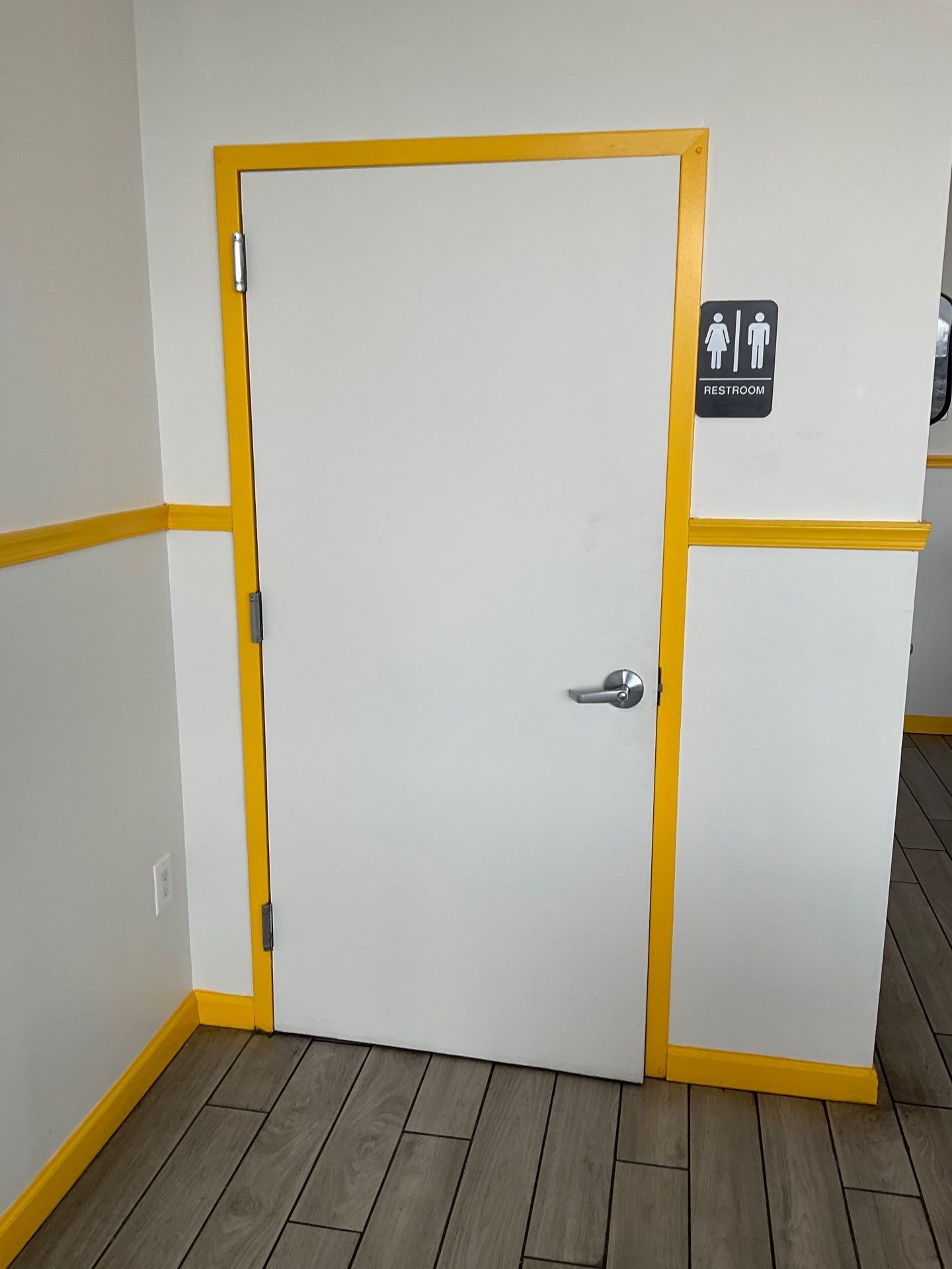 White Restroom Door with Contrasting Yellow Trim