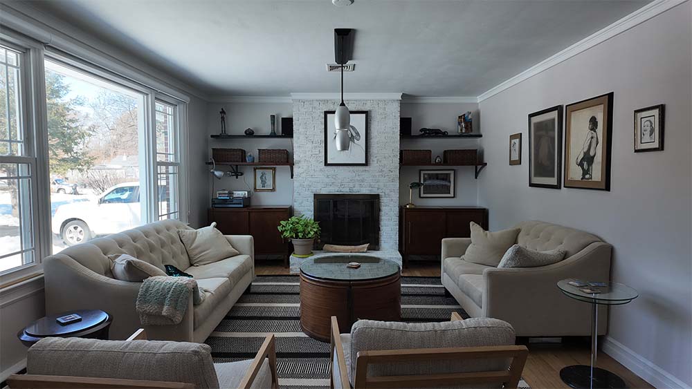 Bright living room with painted walls and fireplace completed by professional house painters in Morrisville PA