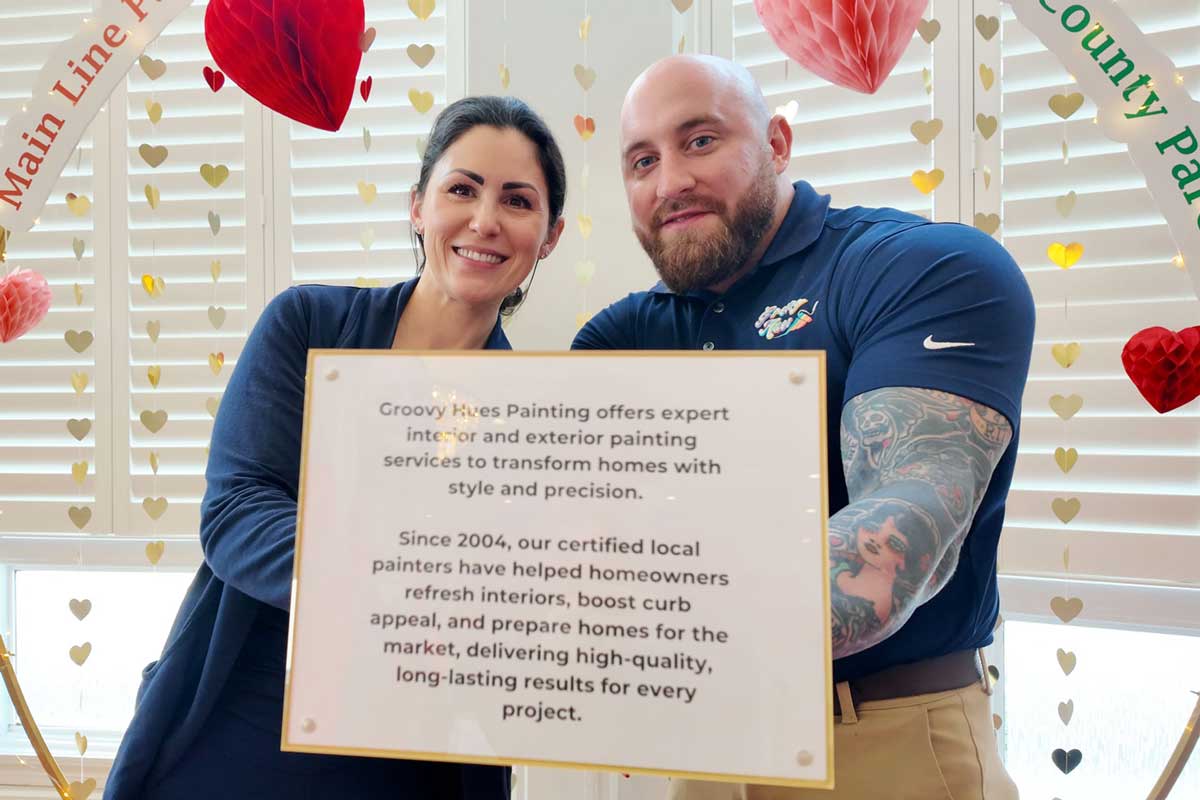 Groovy Hues Painting award winners holding sign about interior and exterior painting services in Philadelphia and Bucks County