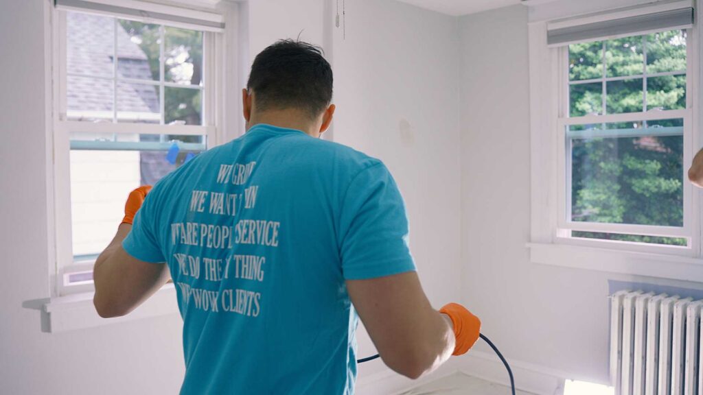 professional painter brush painting interior walls in a home in Philadelphia with detailed finish work