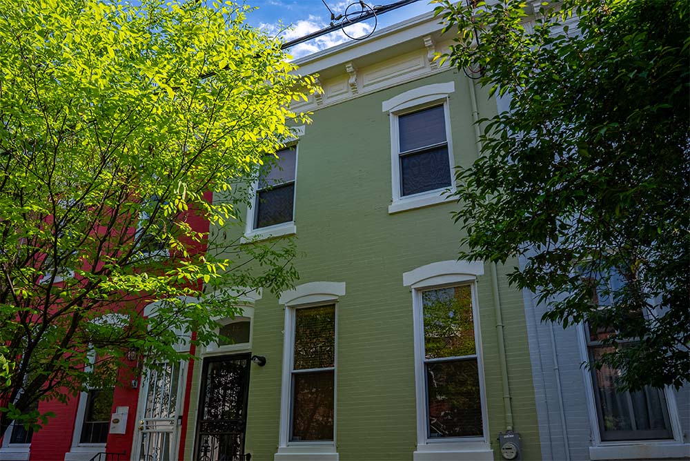 Exterior house painting project in Philadelphia PA featuring olive green siding, white trim, and professionally painted rowhome exterior by Groovy Hues Painting of PhiladelphiaExterior House Painting Project in Philadelphia PA | Groovy Hues Painting of Philadelphia