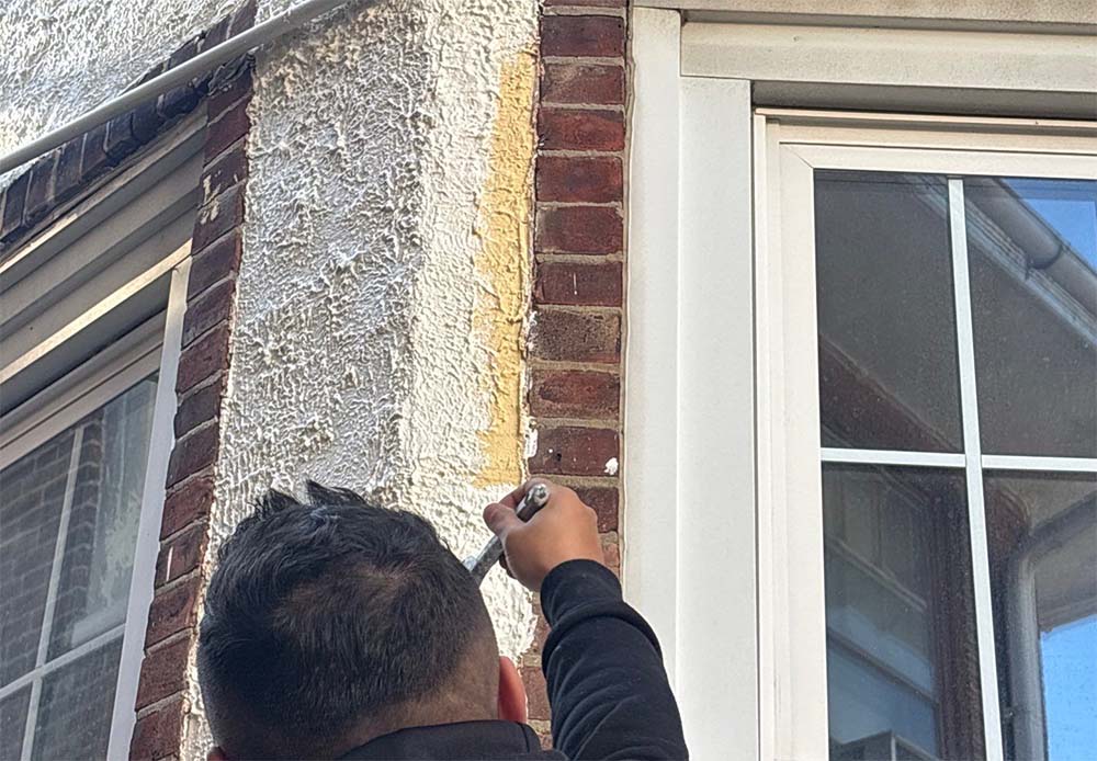 Stucco repair and exterior prep work in Philadelphia PA before professional exterior painting by Groovy Hues Painting of Philadelphia