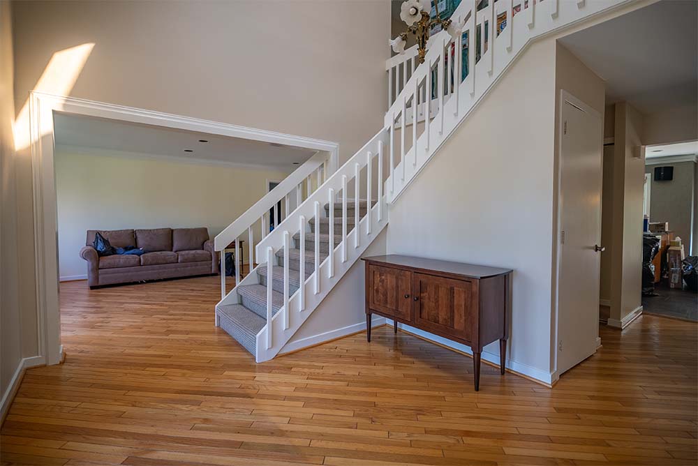 Freshly painted foyer and staircase in a Bucks County home featuring updated interior walls, bright entryway, and professional residential painting services.