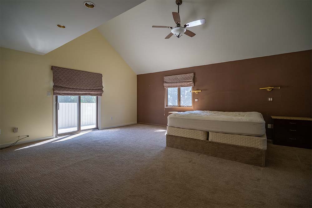 Freshly painted primary bedroom with vaulted ceilings, neutral wall colors, plush carpeting, and abundant natural light in a Bucks County area home.