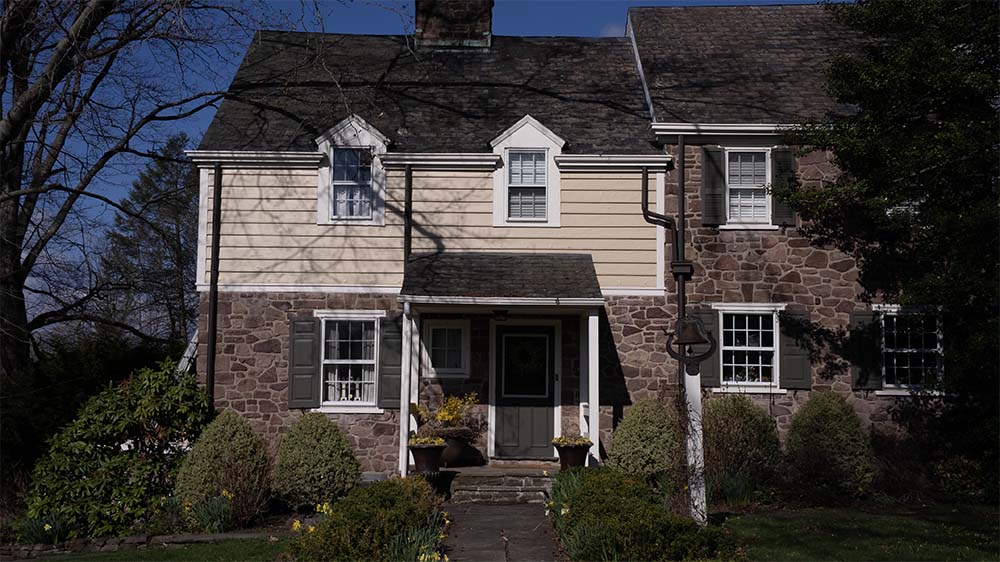 Completed exterior house painting project in Newtown PA featuring freshly painted siding, trim, and shutters by Groovy Hues Painting of Bucks County