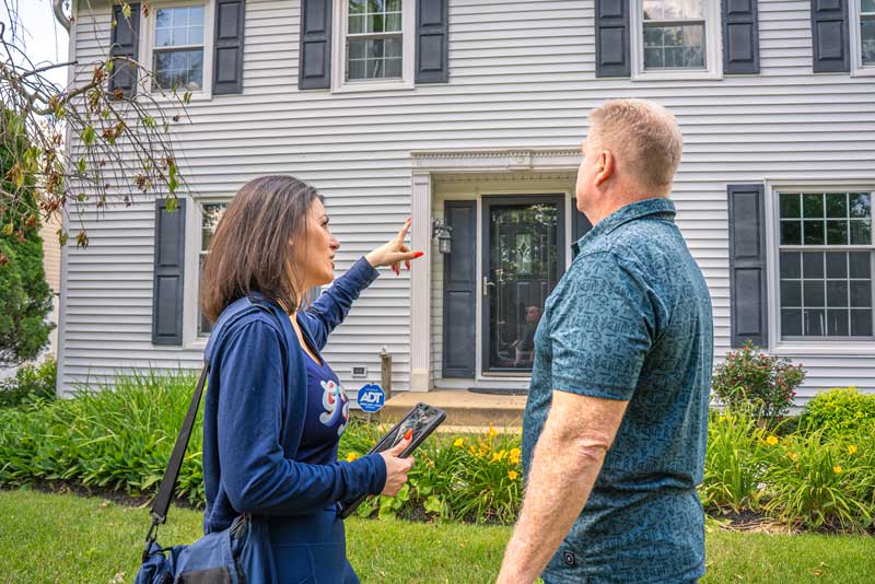 Groovy Hues Painting of Philadelphia consultant inspecting a home's exterior before preparing a painting estimate