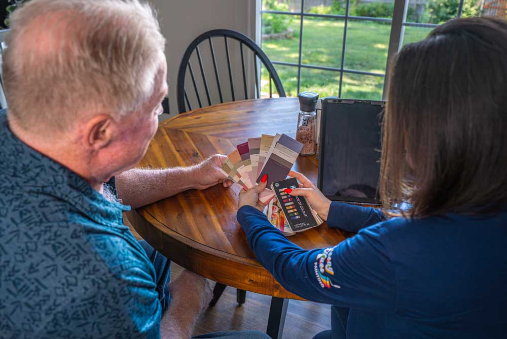 Groovy Hues Painting of Philadelphia helping a homeowner choose interior paint colors during a free color consultation